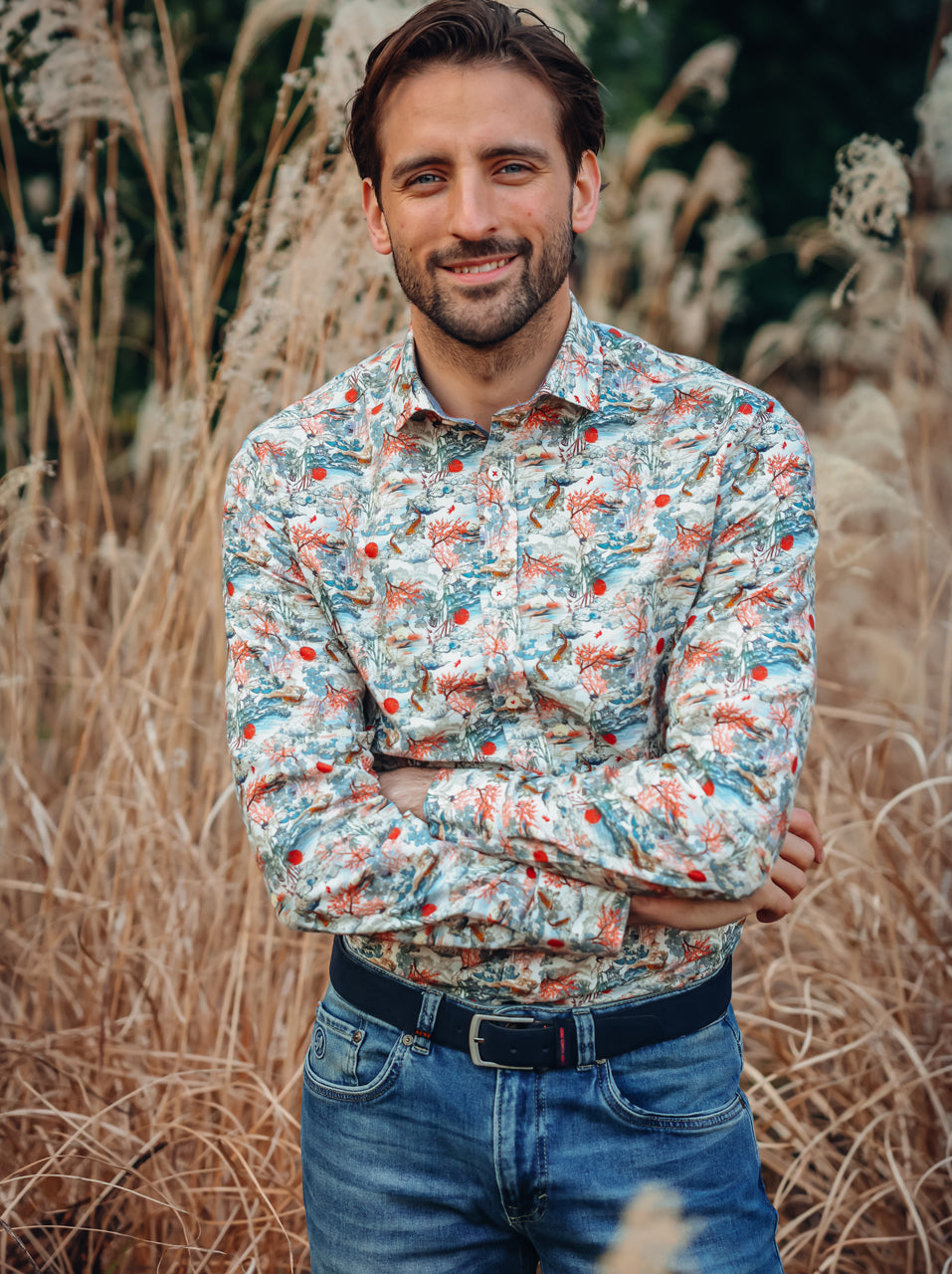 A Fish Named Fred men's Fuji Dream shirt in Off-White, worn by a model in tall pampas grass