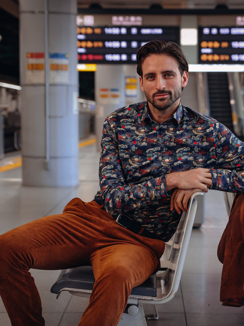 A Fish Named Fred men's Fuji Dream shirt in Navy, worn by a model on a station platform