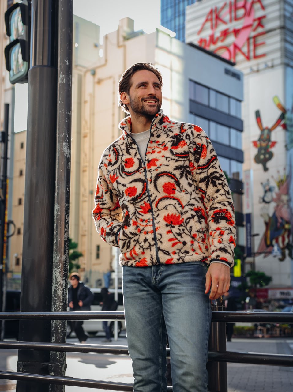 A Fish Named Fred men's Fleece Jacket Blossom in Off-White, worn by a model in Tokyo, outdoor lifestyle shot