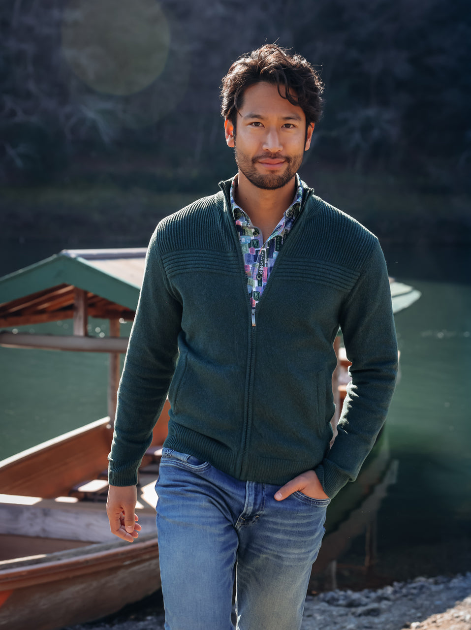 A Fish Named Fred men's Melange cardigan in Dark Green, worn by a model by the riverside