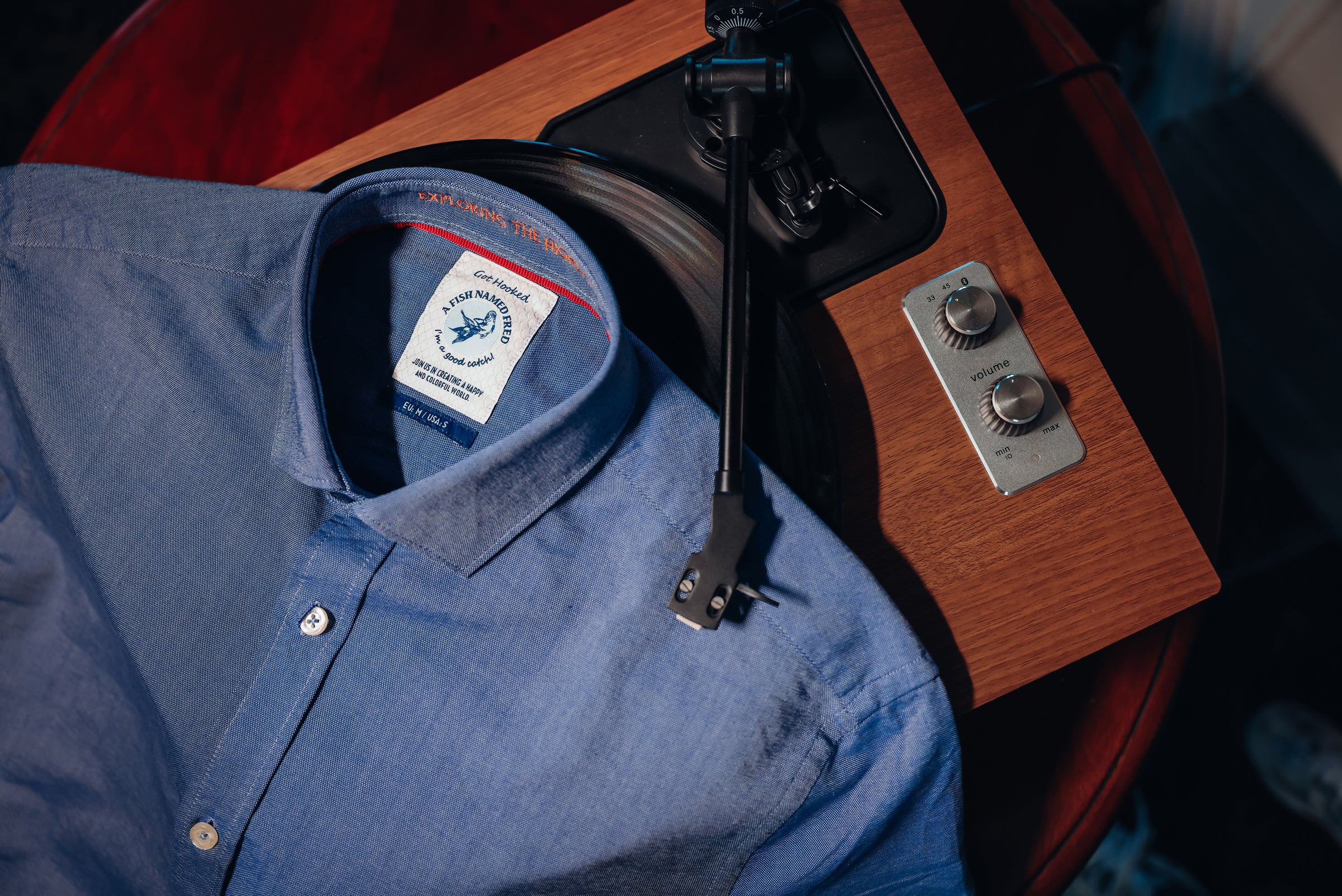 Blue shirt with a label on a wooden surface with tools
