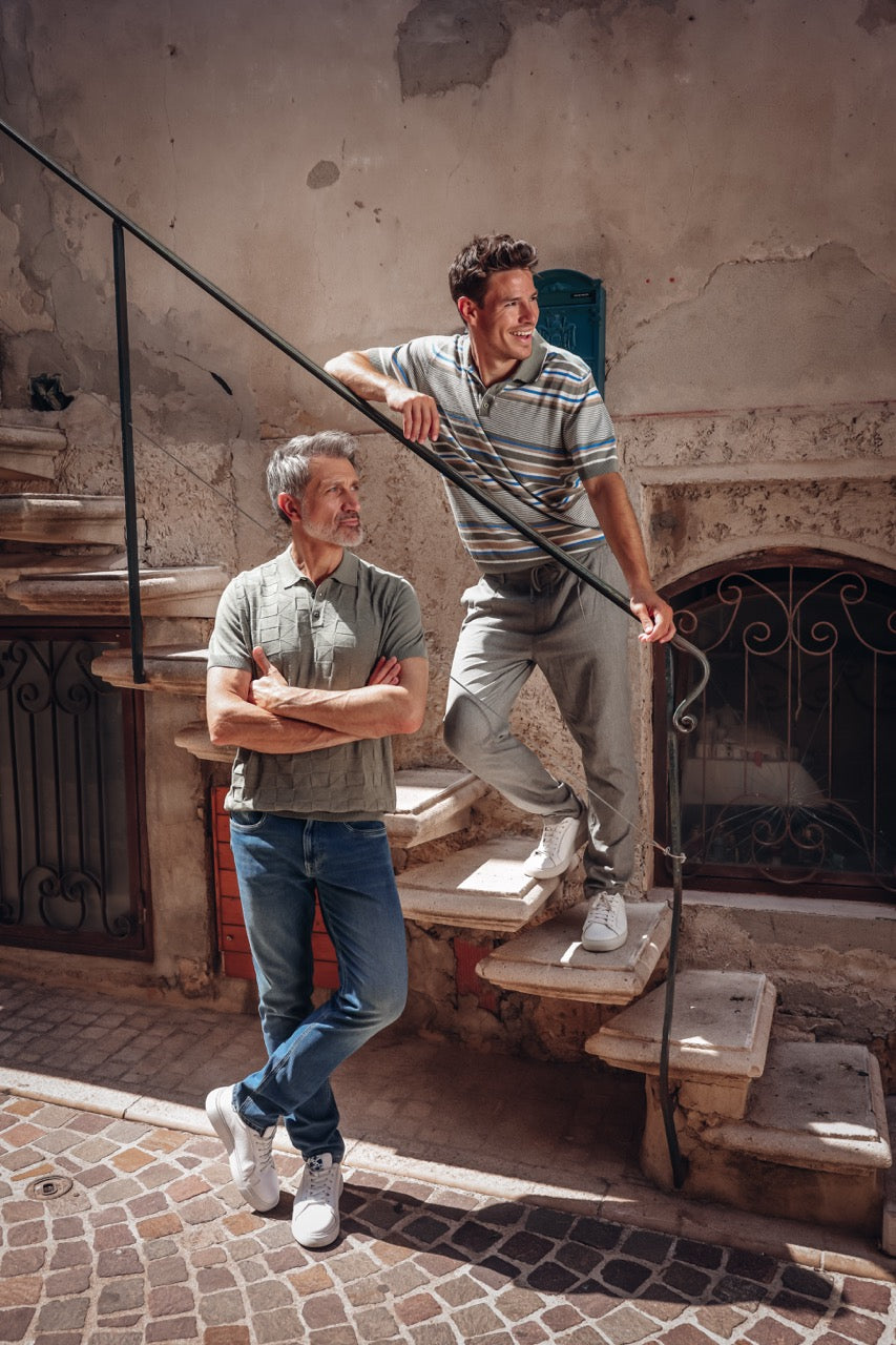 Two men standing on a staircase in an urban setting